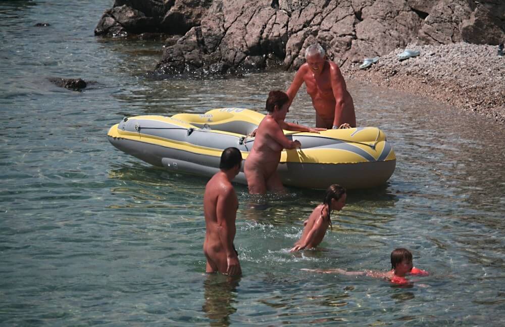 Lone Nudist in Yellow Boat photos - Nudism is a philosophy based on respect and trust