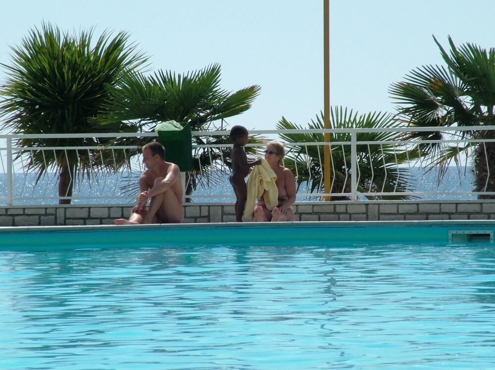Photo of naturists in an outdoor pool - A basic understanding of naturism is necessary